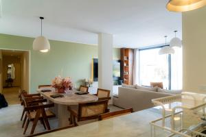 a living room with a table and a couch at Maison soli Marrakech in Bou Khaoua