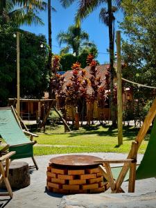 a park with a bench and a swing at Pousada Pássaros Park in Itapoa