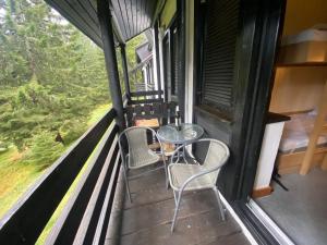 a balcony with a table and chairs on a train at Rogla Gaber Studio in Zreče
