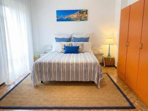 a bedroom with a large bed with blue pillows at Lunigiana e Mare in Aulla