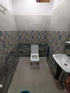 a bathroom with a toilet and a sink at Maurya Royal in Sasarām +19 photos