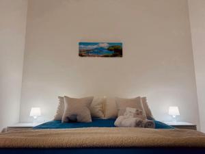 a bedroom with a bed with a painting on the wall at B&B Torrebianca in Aversa +2 photos