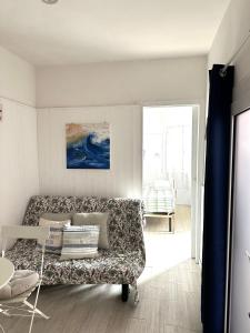 a living room with a couch and a painting on the wall at Villa Bruna B&B in Sanremo