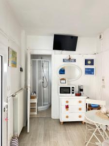 a white bathroom with a sink and a shower at Villa Bruna B&B in Sanremo