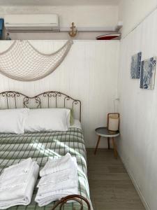 a bedroom with a bed with green and white sheets at Villa Bruna B&B in Sanremo