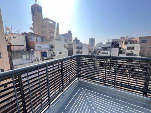 a view of a city from a balcony at 内町3階 高松中心地 広いメゾネット貸切 2ベッドルーム 最大4名 in Takamatsu