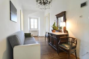 a living room with a couch and a desk at Panorama in Aurisina