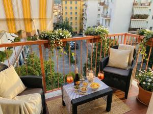 a balcony with two chairs and a table with wine glasses at Lunigiana e Mare in Aulla +31 photos