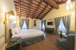 a bedroom with a bed and a couch and a chair at Hotel Villa Barbarich in Mestre +171 photos
