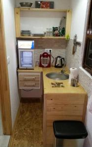 a small kitchen with a sink and a microwave at Apartment STONE in Visoko