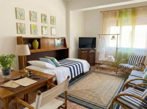 a bedroom with a bed and a desk and a table at Lunigiana e Mare in Aulla