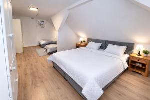 a bedroom with a large white bed and two tables at Dom Przyjaźni in Kędzierzyn-Koźle +14 photos
