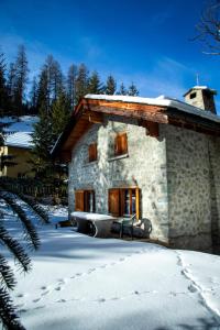 a small stone building with snow on the ground at Chalet Gulas - La Punt-Chamues-ch in La Punt-Chamues-ch
