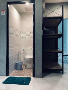a bathroom with a toilet and a shower with a rug at Puak Taem Boutique Hotel in Chiang Mai +46 photos