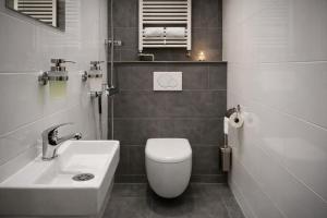 a bathroom with a white toilet and a sink at Boshuisje in Enschede +28 photos