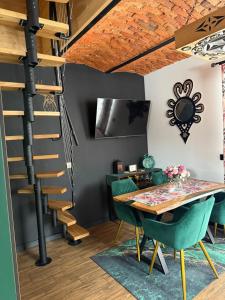 a spiral staircase in a room with a table and chairs at Domek w górach in Załuczne +10 photos