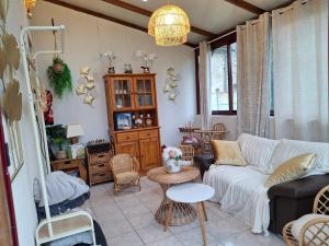a living room with a couch and a table at maison village 3 chambres 30 minutes du zoo de beauval in Saint-Cyran-du-Jambot