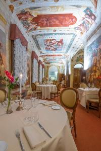 a dining room with tables and ceilings with paintings at Hotel Villa Barbarich in Mestre