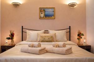 a bedroom with a large bed with towels on it at Agriturismo Residence Molle con piscina in Carpignano Salentino +86 photos