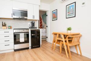 a kitchen with a black and white stove and a table at Pint-Sized on Poplar in Cambridge +13 photos