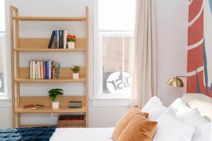 a bedroom with a bed and a book shelf at Pint-Sized on Poplar in Cambridge