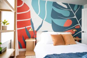 a bedroom with a bed with a colorful wall at Pint-Sized on Poplar in Cambridge