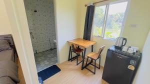 a small room with a desk and a table with two chairs at Thung Setthi Homestay&Cafe5 in Chiang Dao +22 photos