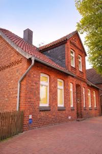 a red brick house with a black roof at Ferienhaus Anna in Winsen