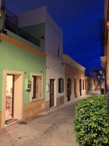 a row of buildings on a street at night at Alcazaba Home in Almería