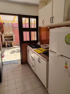a kitchen with a white refrigerator and a stove at Hogape in Posadas