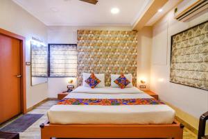 a bedroom with a large bed in a room at Hotel Krishna Inn in Bhiwandi