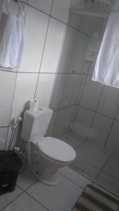 a white bathroom with a toilet and a shower at Hotel Santa Thereza in Bofete +21 photos