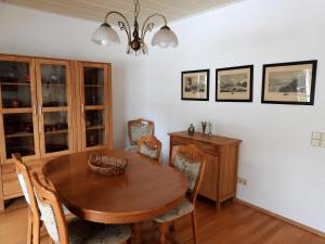 a dining room with a wooden table and chairs at Auf der Heide - Ferienhaus für 6 Personen in Borkheide