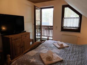 a bedroom with a bed with towels on it at Auf der Heide - Ferienhaus für 6 Personen in Borkheide