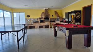a room with two ping pong tables and a fireplace at Casaazulvaleparaiba in Jacareí
