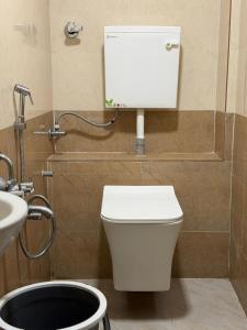 a bathroom with a toilet and a sink at Hotel Al Mehraj in Mumbai