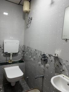 a dirty bathroom with a toilet and a sink at Hotel Al Mehraj in Mumbai