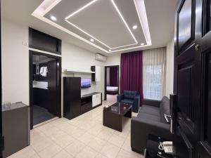 a living room with a couch and a bed in a room at ZORA Suites hotel in Jounieh
