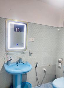 a bathroom with a blue sink and a toilet at Luna Fortuna Villa in Tangalle +27 photos