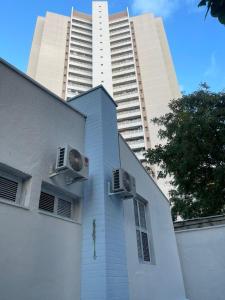 a building with two air conditioners and a tall building at Pousada Casa Bali in Fortaleza