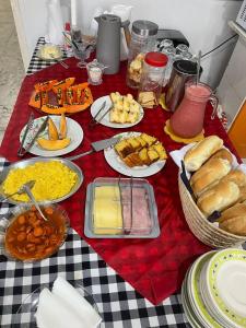 a table with plates of food on a checkered table cloth at Pousada Casa Bali in Fortaleza +11 photos