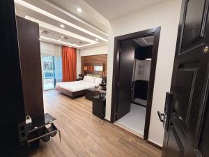 a living room with a bed and a television at ZORA Suites hotel in Jounieh