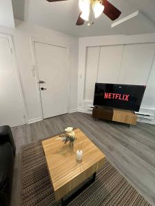 a living room with a tv and a coffee table at Lovely apartment for rent in Vitry-sur-Seine