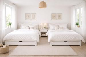 two beds in a bedroom with white walls and windows at Ali House in Lahore