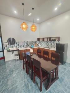 a dining room with a table and chairs at Cherry House villa in Hà Tiên