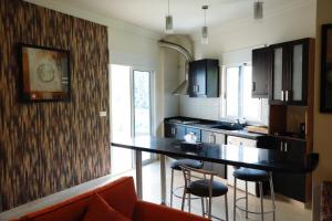 a kitchen with a table and some chairs in it at ZORA Suites hotel in Jounieh