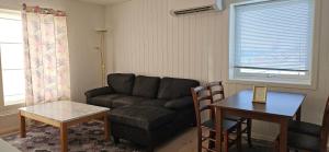 a living room with a couch and a table at Håkon Gjestehus in Olderdalen