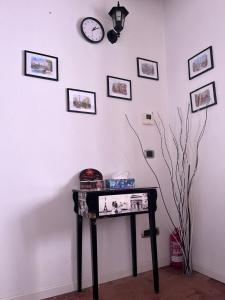 a table in a room with a clock on a wall at B&B Villa Friedmann Nonantola Modena in Nonantola +66 photos