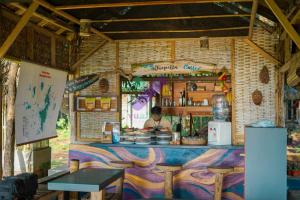 a person standing behind a counter in a food stand at Bunga Jabe in Karimunjawa