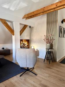 a living room with a chair and a fireplace at Apartman Romić in Vrlika